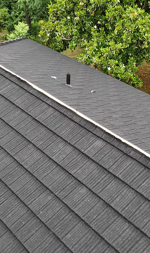 Side-by-side comparison of metal roofing and asphalt shingles on a Denton home