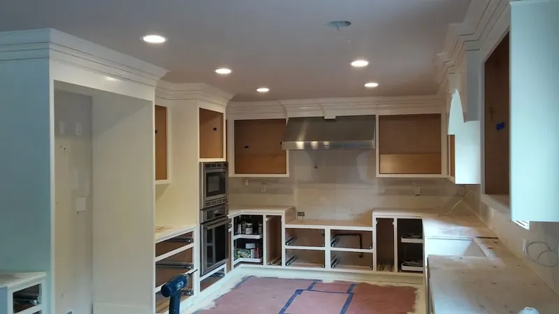 Kitchen interior with recessed lighting and cabinets