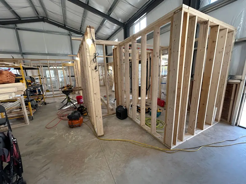 Wood-framed room layout inside a metal building