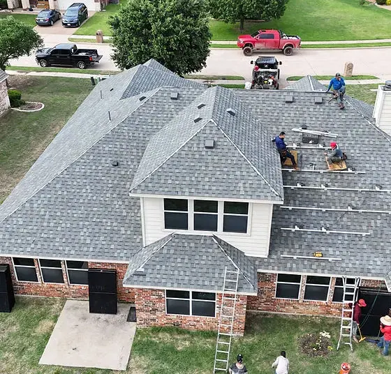 Aerial view of a shingle roof with work in progress